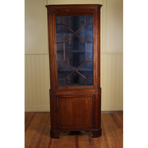 226 - A 19TH CENTURY MAHOGANY CORNER CABINET the moulded cornice above an astragal glazed door with blind ... 