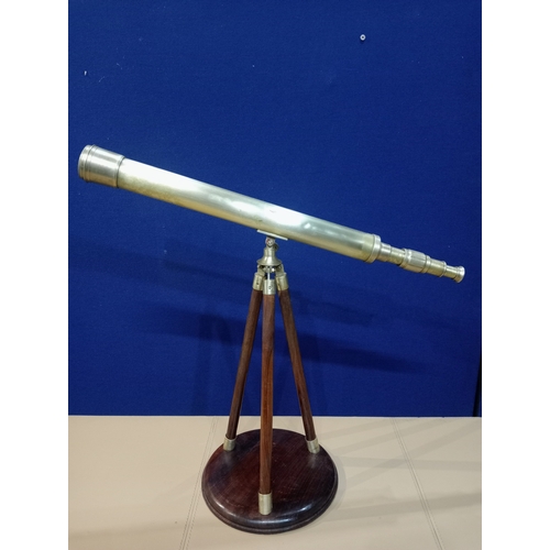 236 - A BRASS TABLE TOP TELESCOPE with tripod support on a circular mahogany base 54cm (h) x 61cm (w) x 24... 