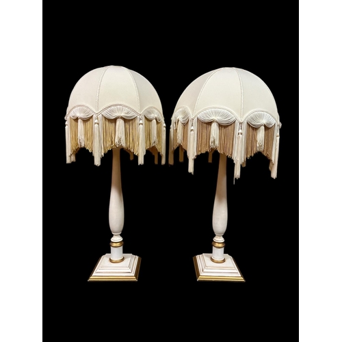 287 - A PAIR OF WHITE PAINTED AND PARCEL GILT TABLE LAMPS each with a baluster column raised on a square s... 