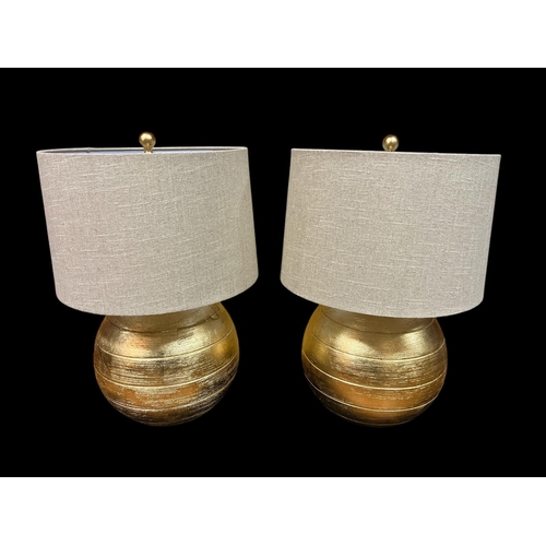 289 - A PAIR OF CONTINENTAL GILT TABLE LAMPS each of bulbous form with shades 67cm (h)