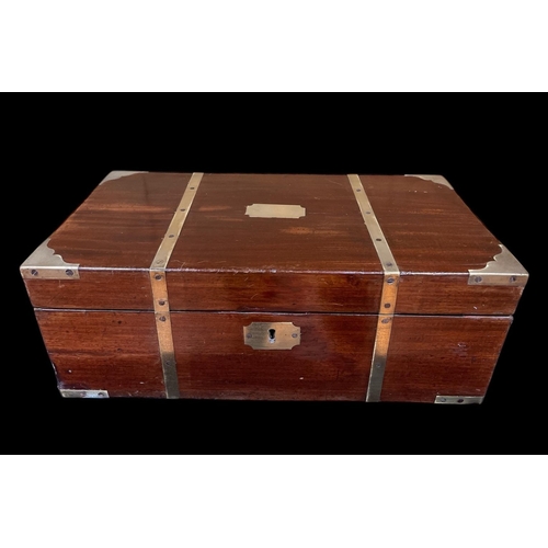 292 - A GEORGIAN MAHOGANY AND BRASS BOUND STATIONERY BOX the rectangular hinged lid containing a tooled le... 