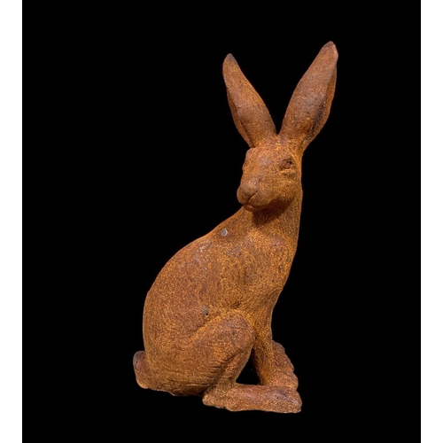 297 - A CAST IRON FIGURE modelled as a hare shown seated on a naturalistic base 39cm (h)