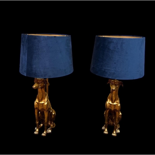 301 - A PAIR OF CONTINENTAL GILT FIGURAL TABLE LAMPS each modelled as a hound shown seated with shades 71c... 