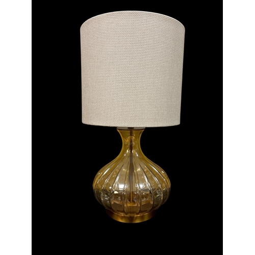 302 - A CONTINENTAL RIBBED GLASS TABLE LAMP on a gilt circular foot with shade 73cm (h)