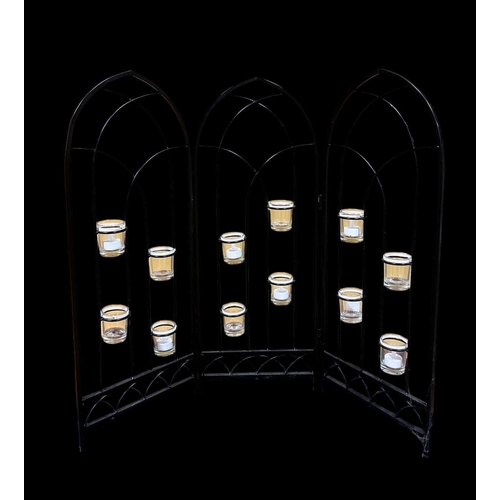 303 - A WROUGHT IRON THREEFOLD TEALIGHT CANDLE SCREEN of gothic outline 81cm (h) x fully extended 95cm (w)