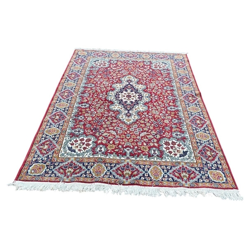 352 - AN ORIENTAL RUG the indigo, wine, light blue and beige ground with central panel filled with palmett... 