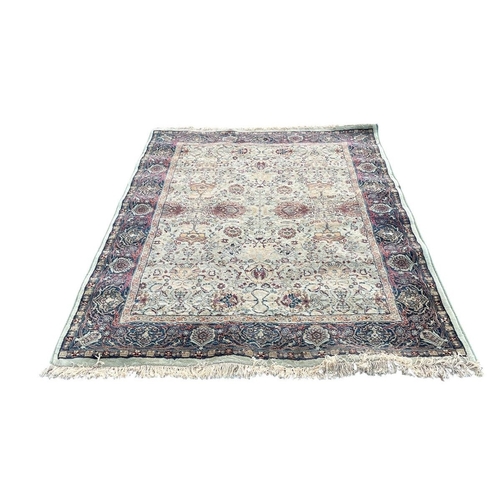 354 - AN ORIENTAL RUG the multicolour ground with central panel filled with palmettes flowerheads and foli... 