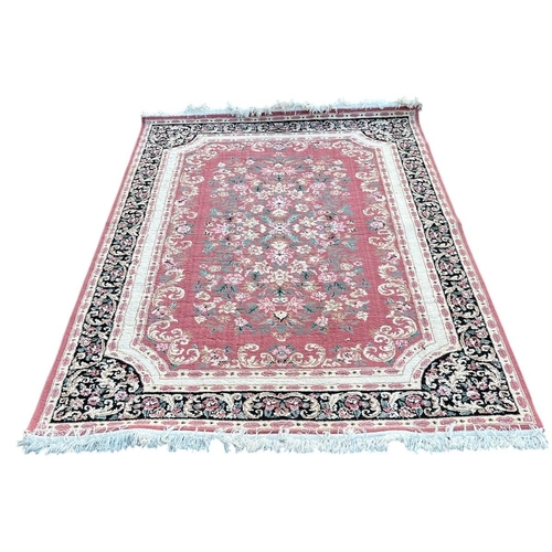 355 - AN ORIENTAL RUG the white, light pink and blue ground with central panel filled with floral sprays w... 