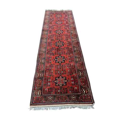 357 - A BOKHARA WOOL RUG the wine and indigo ground with central panel filled with stylised flowerheads, p... 