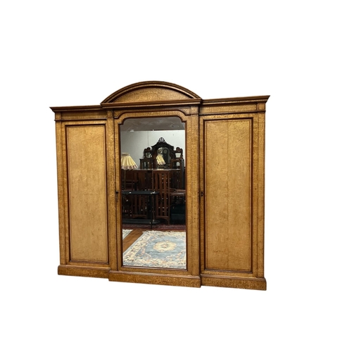 36 - A GOOD QUALITY 19TH CENTURY FLAMED OAK FITTED WARDROBE the rectangular arched pediment above a centr... 