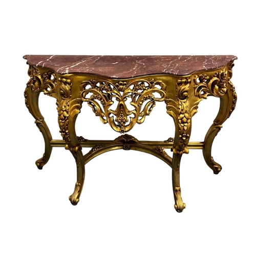 376 - A CONTINENTAL CARVED GILTWOOD AND MARBLE CONSOLE TABLE of serpentine outline with rouge veined marbl... 