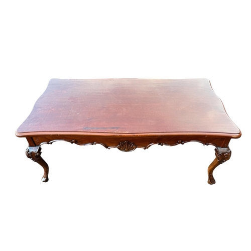 381 - A MAHOGANY COFFEE TABLE of serpentine outline the shaped top above a carved apron on cabriole legs 1... 