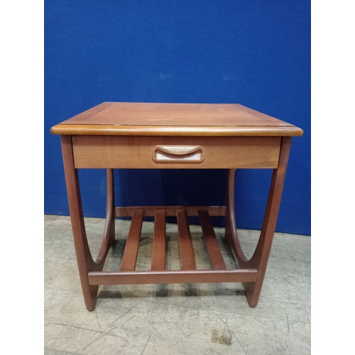 388 - A G-PLAN TEAK LAMP TABLE of rectangular form the shaped top with frieze drawer on U-shaped supports ... 