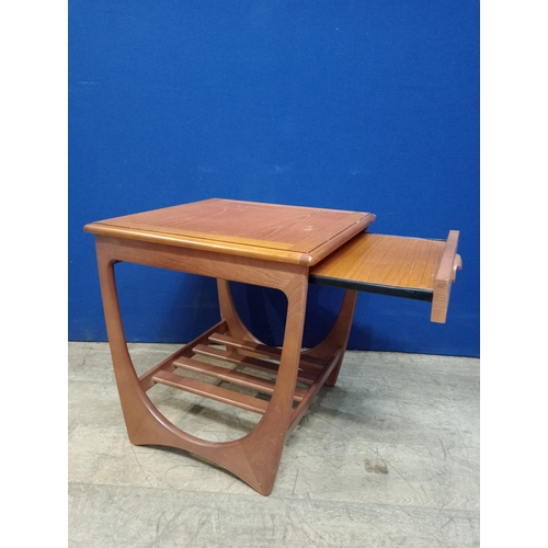 388 - A G-PLAN TEAK LAMP TABLE of rectangular form the shaped top with frieze drawer on U-shaped supports ... 