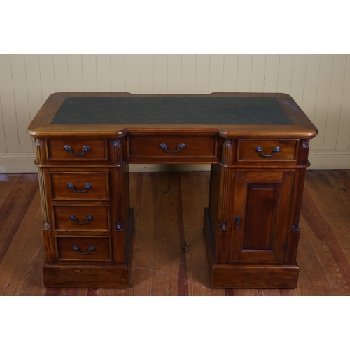 40 - A MAHOGANY PEDESTAL DESK of rectangular breakfront outline the shaped top with rexine writing surfac... 