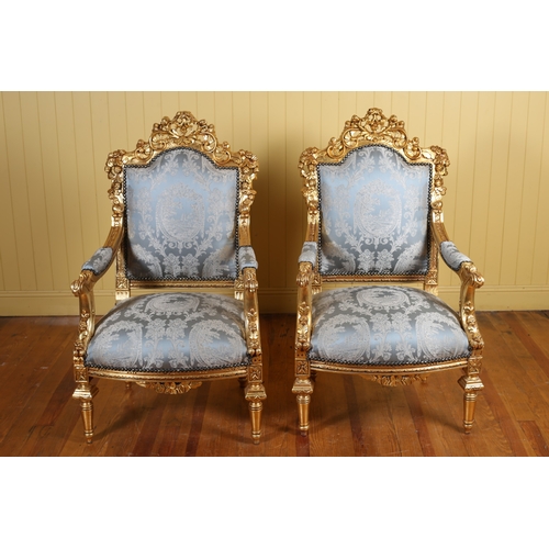 402 - A PAIR OF CONTINENTAL CARVED GILTWOOD AND UPHOLSTERED ARMCHAIRS each with a pierced foliate and flow... 