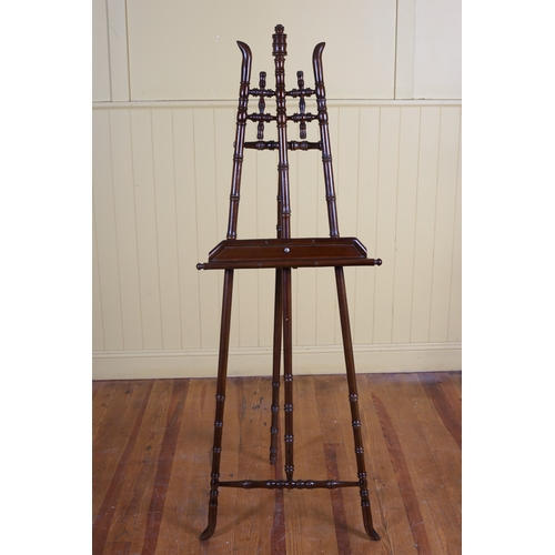 403 - A STAINED BEECHWOOD EASEL with simulated bamboo uprights joined by baluster stretchers with adjustab... 