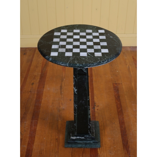 405 - A GREEN AND BLACK VEINED MARBLE CHESS TABLE of circular outline the shaped top with inlaid panels ab... 