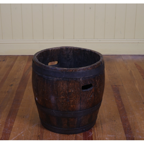 47 - A VINTAGE OAK AND STEEL BOUND BARREL of typical form with pierced carrying handles 28cm (h) x 36cm (... 