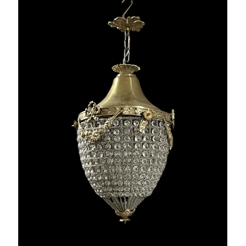 531 - A CONTINENTAL GILT BRASS AND CUT GLASS CENTRE LIGHT of dome form inset with faceted pendants the cir... 