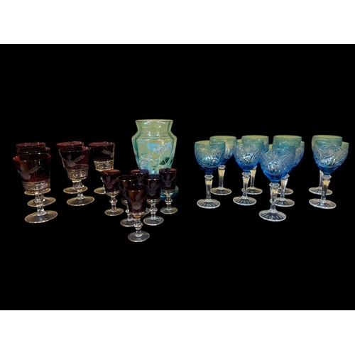 553 - A SUITE OF TWELVE RUBY GLASS CLEAR GLASS AND ENGRAVED WINE GLASSES AND LIQUEUR GLASSES, a suite of n... 