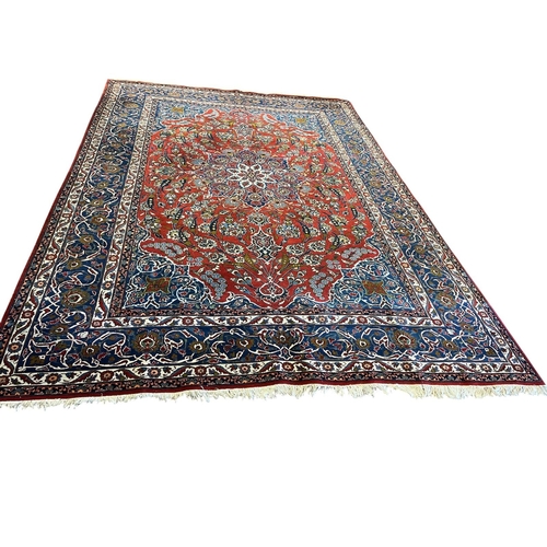 563 - A KESHAN WOOL RUG the indigo, wine and white ground with central panel filled with flowerheads and f... 