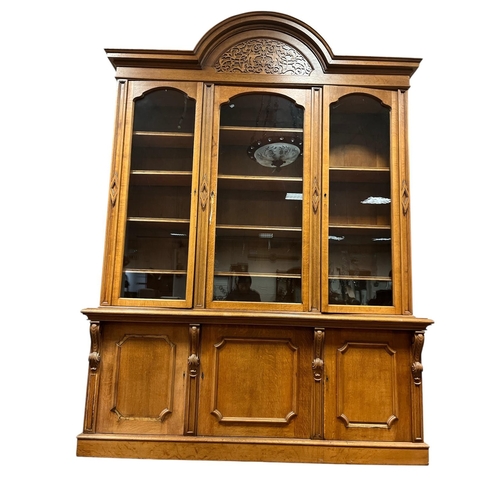 66 - AN EDWARDIAN MAHOGANY LIBRARY BOOKCASE the rectangular arched cornice with blind fretwork frieze abo... 