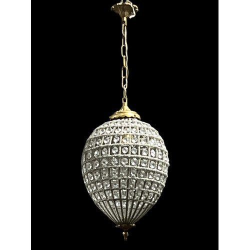 181 - A CONTINENTAL GILT BRASS AND CUT GLASS CENTRE LIGHT of bulbous form with faceted pendant inset hung ... 