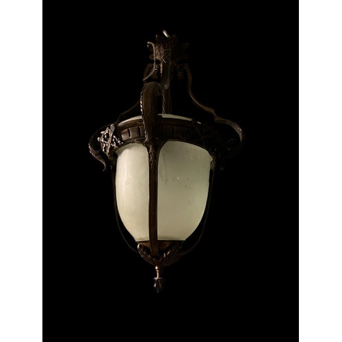 662 - A CONTINENTAL GILT BRASS AND FROSTED GLASS CENTRE LIGHT of dome form hung with foliate cast scroll a... 