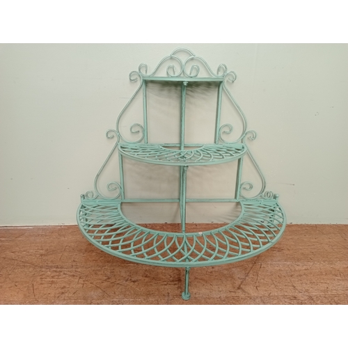 276 - A CAST METAL THREE TIER MULTIFLORA STAND of demi lune outline with pierced lattice work shelves on t... 