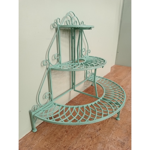 276 - A CAST METAL THREE TIER MULTIFLORA STAND of demi lune outline with pierced lattice work shelves on t... 