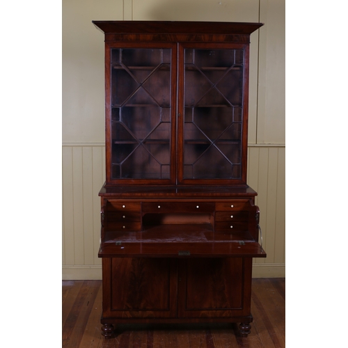 5 - A 19TH CENTURY MAHOGANY SECRETAIRE LIBRARY BOOKCASE the out swept moulded cornice above a pair of as... 