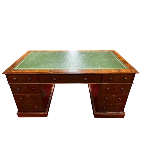 A 19TH CENTURY WALNUT AND MAHOGANY PEDESTAL DESK of rectangular outline with tooled leather inset above three frieze drawers raised on twin three drawer pedestals and platform support 44cm (h) x 93cm (w) x 65cm (d)