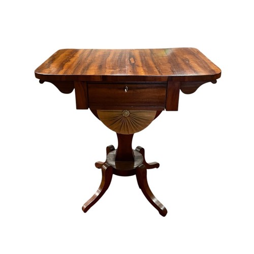 A REGENCY ROSEWOOD DROP LEAF WORK TABLE the rectangular hinged top above a frieze drawer with work basket raised on a rectangular spreading column and platform base with splayed legs 74cm (h) x 73cm (w) x 46cm (d)