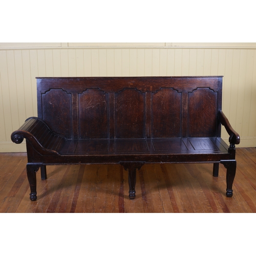 A 19TH CENTURY OAK BENCH the panel back and seat with scroll end on turned moulded legs 104cm (h) x 194cm (w) x 67cm (d)