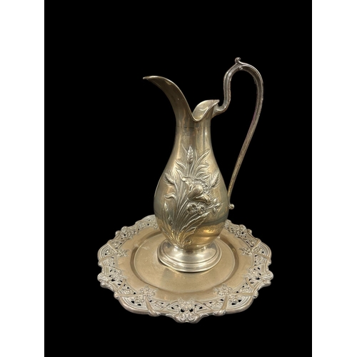 A CONTINENTAL SILVER WATER JUG embossed with floral decoration together with A SILVER TRAY with pierced rim (2)