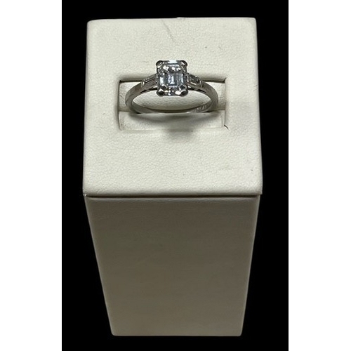 A PLATINUM AND EMERALD CUT DIAMOND SOLITAIRE DRESS RING with baguette diamond shoulder stones total 2ct approx.
