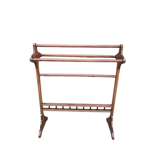 A VINTAGE OAK FIVE BAR TOWEL RAIL on splayed legs 97cm (h) x 26cm (w) x ...