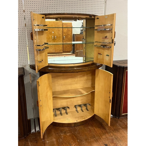 11 - AN ART DECO COCKTAIL CABINET of demi lune outline the shaped top with cupboards containing a glazed ... 