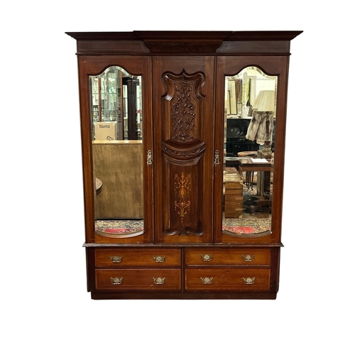 352 - AN EDWARDIAN CARVED MAHOGANY AND SATINWOOD INLAID TWO DOOR WARDROBE of breakfront outline the shaped... 