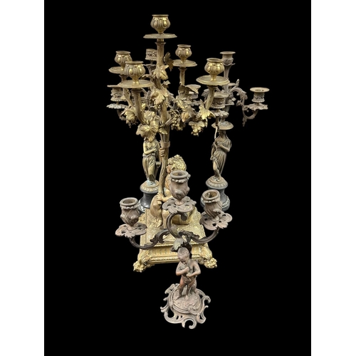 472 - A PAIR OF VINTAGE BRASS FIGURAL FIVE BRANCH CANDELABRA raised on a black marble platform 46cm (h), A... 