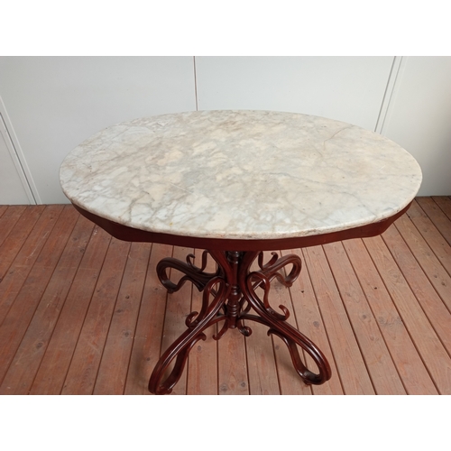 36 - A FRENCH BISTRO BENTWOOD TABLE of oval outline the shaped top with white veined marble top above an ... 