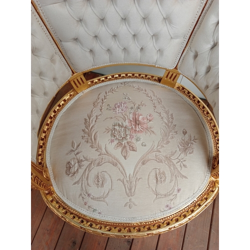59 - A PAIR OF CONTINENTAL CARVED GILTWOOD AND UPHOLSTERED TUB SHAPED ARMCHAIRS each with a ribbon tied a... 