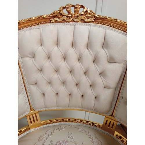 59 - A PAIR OF CONTINENTAL CARVED GILTWOOD AND UPHOLSTERED TUB SHAPED ARMCHAIRS each with a ribbon tied a... 