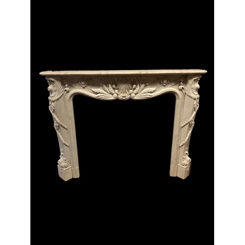 386 - A WHITE MARBLE CHIMNEY PIECE the serpentine shelf above a foliate carved frieze with conforming jamb... 