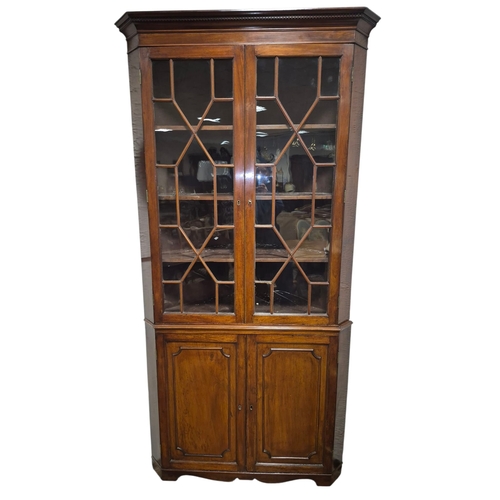 5 - A GOOD GEORGIAN MAHOGANY CORNER CABINET the dentil moulded cornice above a pair of astragal glazed d... 