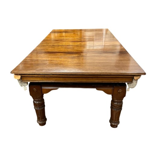 AN EDWARDIAN MAHOGANY DINING / SNOOKER TABLE with five loose leaves, the slate bed complete with balls, marker and cues Overall length 257cm (l) x 135cm (w)