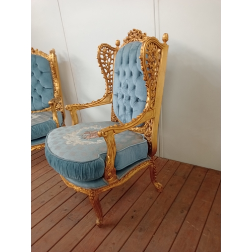 41 - A PAIR OF CONTINENTAL CARVED GILTWOOD AND UPHOLSTERED WING CHAIRS each with flowerhead and foliate c... 