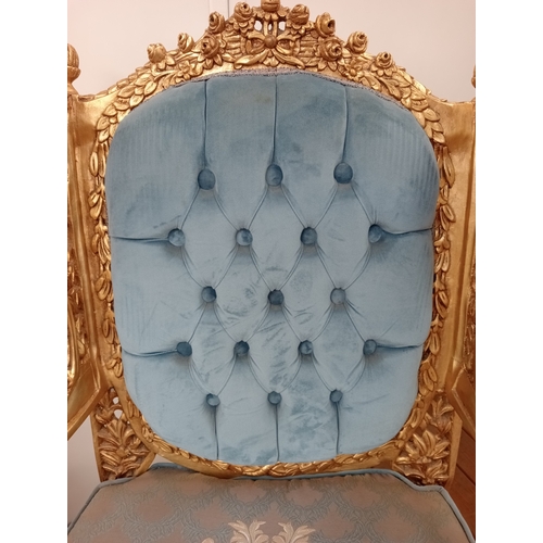 41 - A PAIR OF CONTINENTAL CARVED GILTWOOD AND UPHOLSTERED WING CHAIRS each with flowerhead and foliate c... 