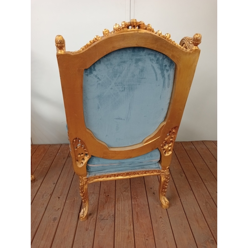 41 - A PAIR OF CONTINENTAL CARVED GILTWOOD AND UPHOLSTERED WING CHAIRS each with flowerhead and foliate c... 